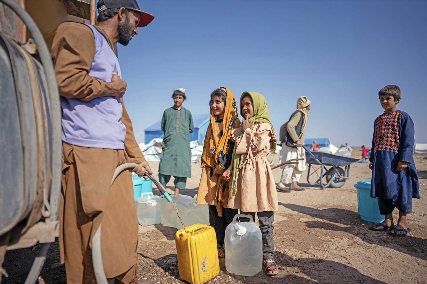 Kids getting water from a truck
